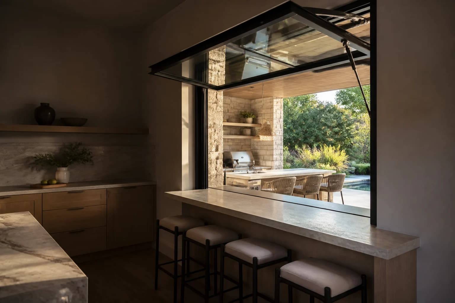 Black gas-strut pass-through window fully open between a kitchen and patio bar